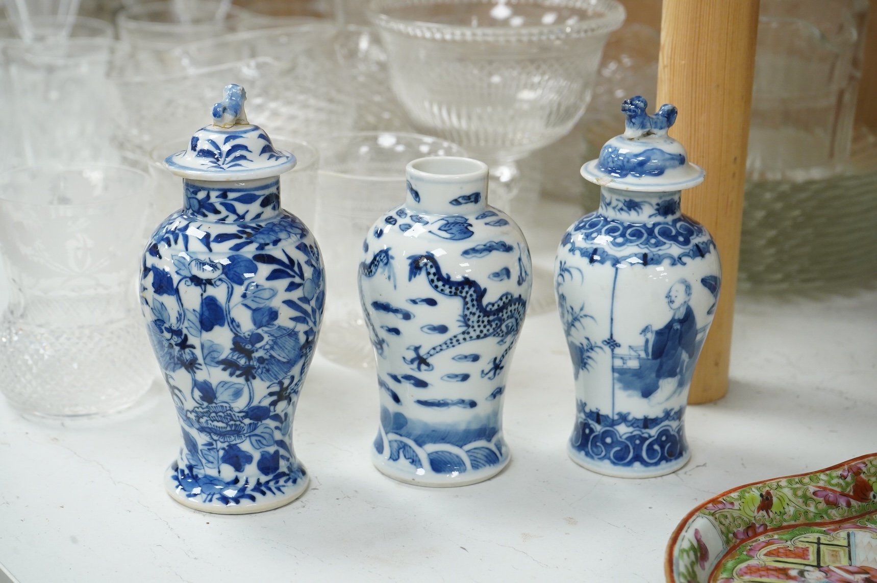 A collection of 19th century Chinese porcelain to include a pair of famille rose candlesticks, dish and a pair of blue and white baluster vases and covers